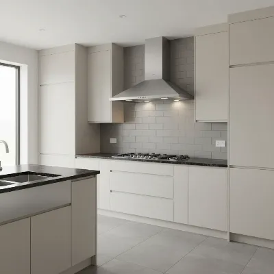 A sleek stainless steel wall mount range hood integrated into a modern kitchen with minimalist cabinetry and dark countertops, illustrating proper size and mounting height.